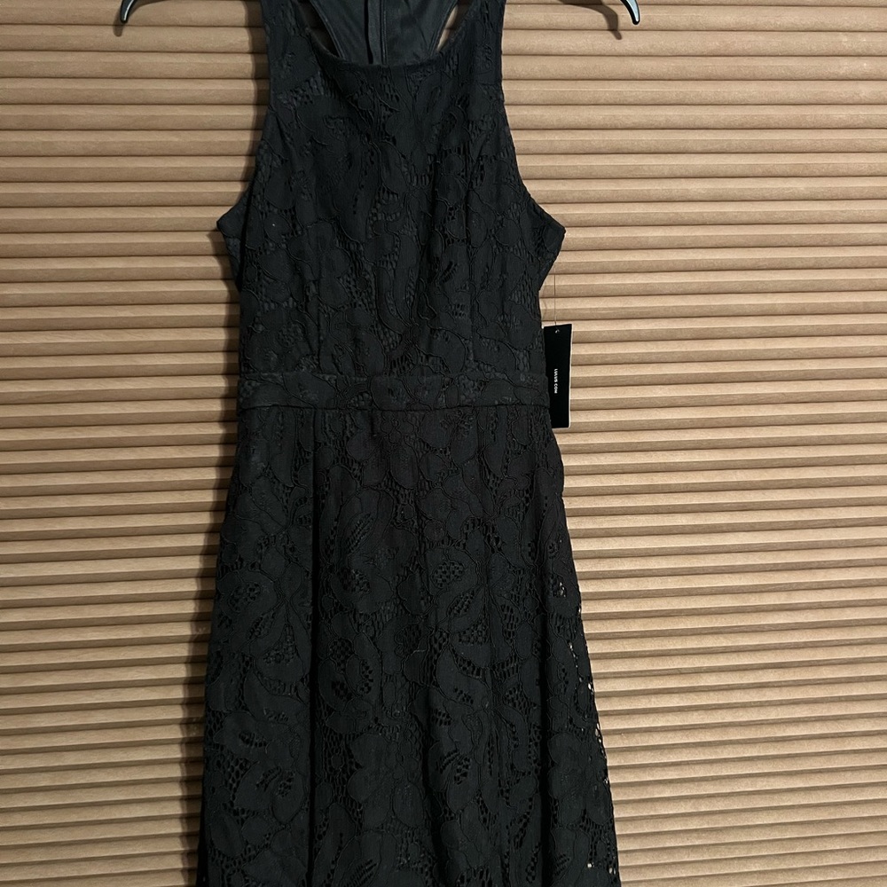 LULU’s Adorable black mini dress with geometrical back cut outs.